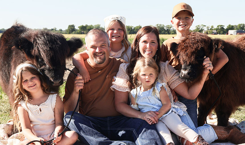 family photo with highland cow